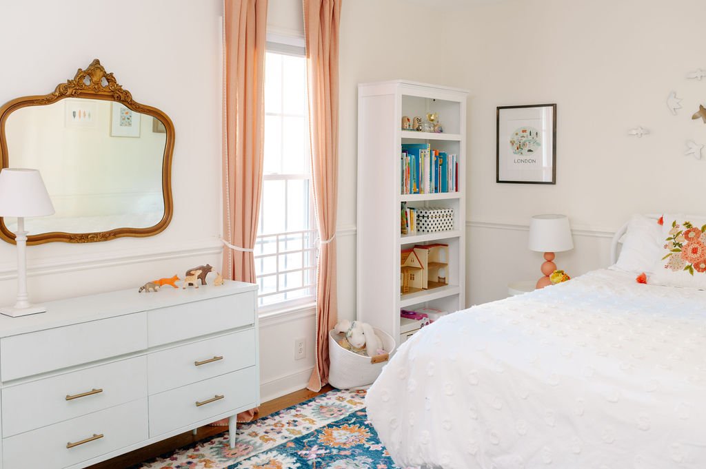 Vintage gold mirror, mint green dresser, coral curtains, Anthropologie rug, bookcase, white bedding