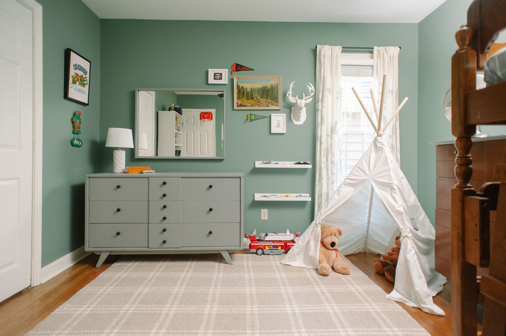 Little boy's room in Sherwin Wiliiams Privilege Green with midcentury furniture and plaid rug