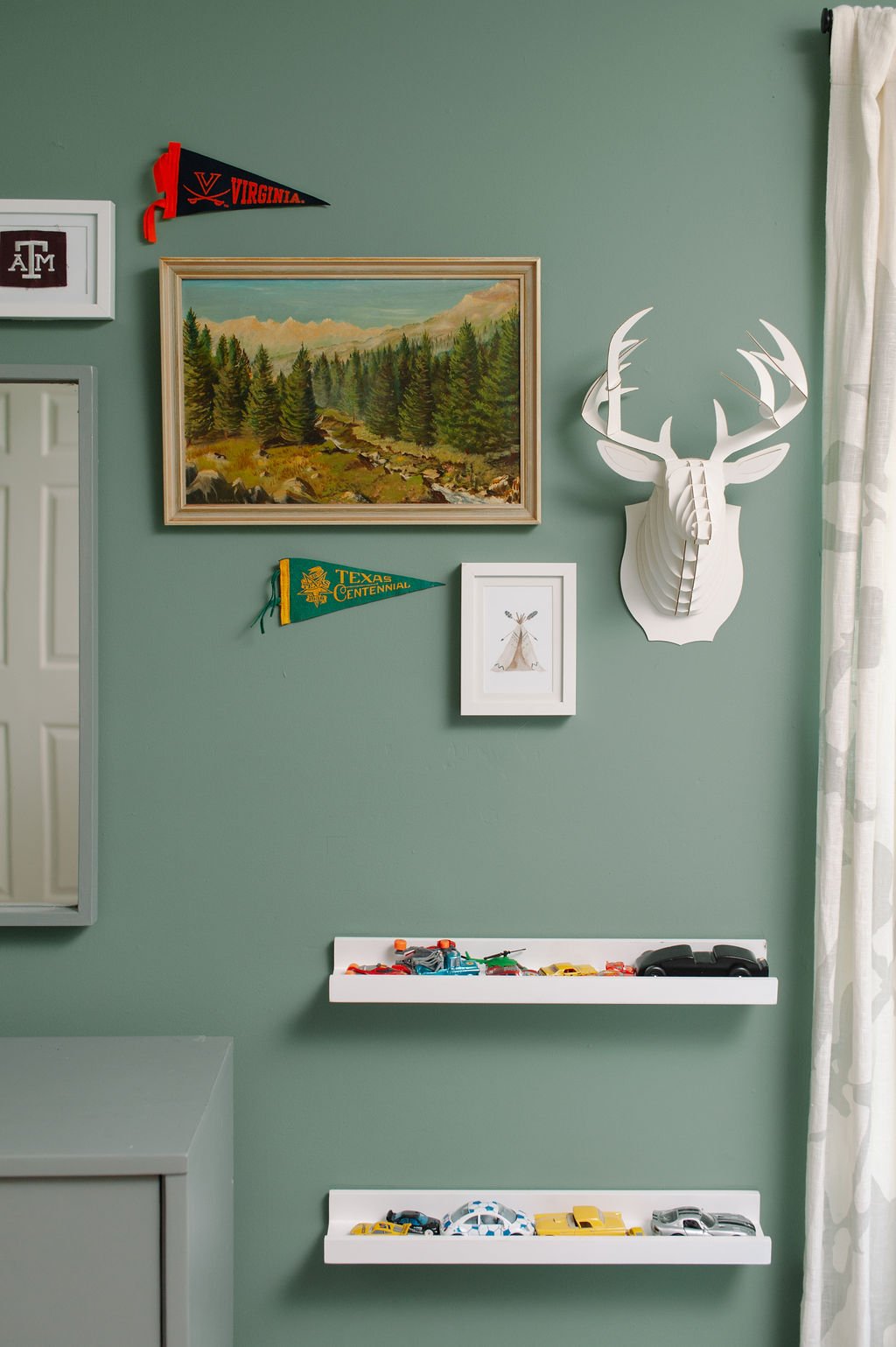 Boys room gallery wall with vintage art and penants