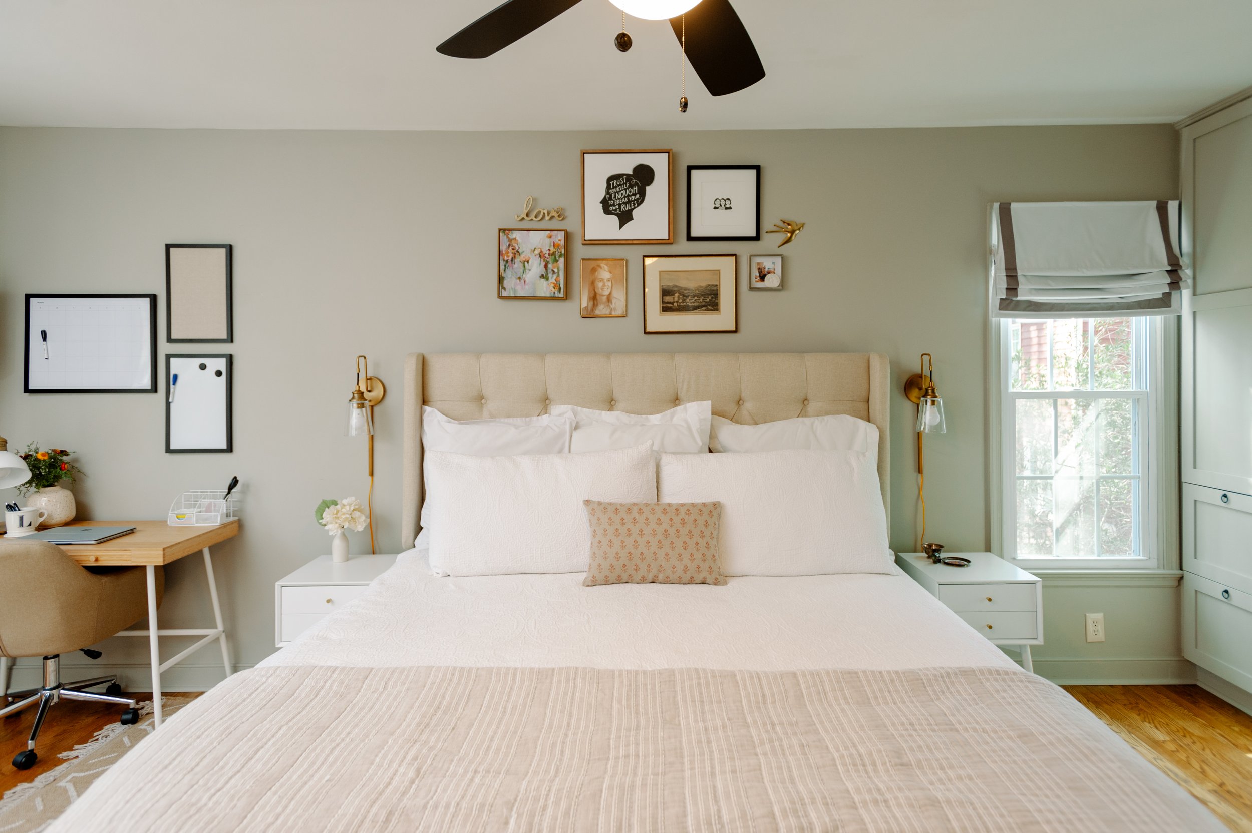 Beige Upholstered Headboard in Sherwin Williams Mindful Gray with Gallery Wall and Studio McGee Pillow; Brass Plug-In Sconces from Wayfair and Target Bedding